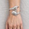 Silver-tone angelfish bangle design with sculpted stripes and sweeping fins