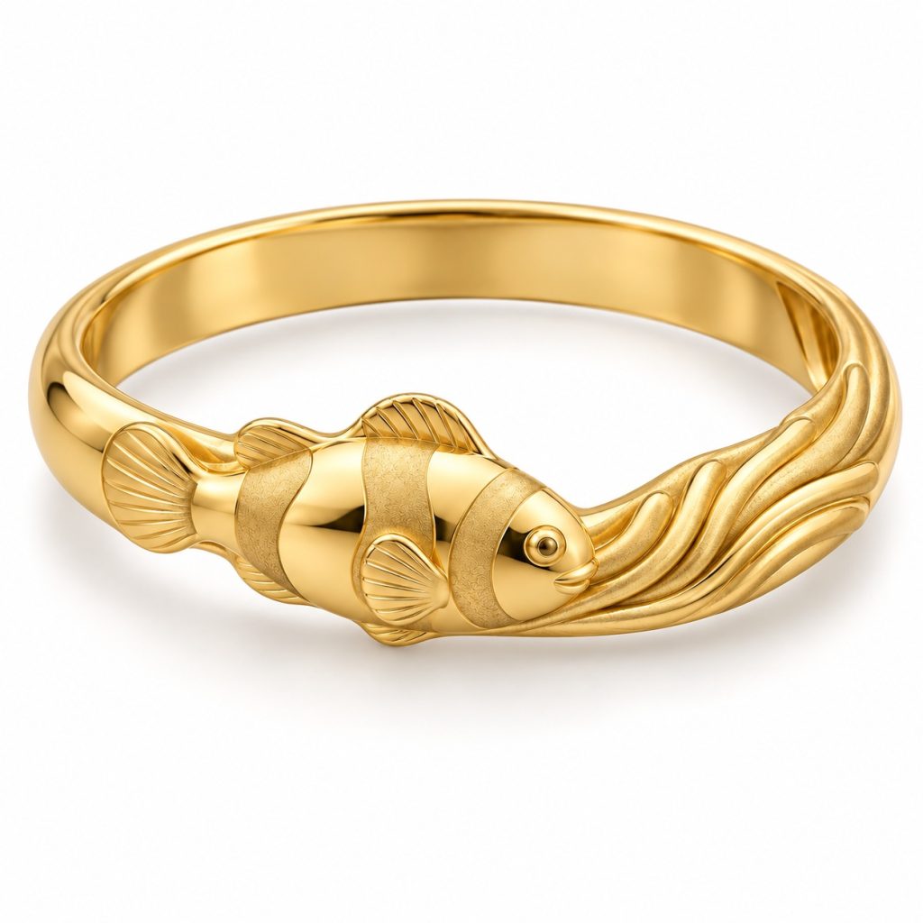 Gold-tone clownfish bangle with raised fish and wave details