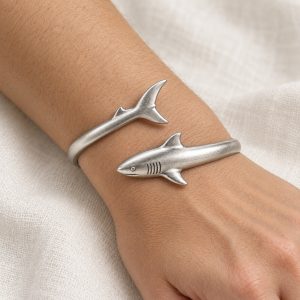 Silver-tone shark bangle design with sculpted fins and engraved gill details