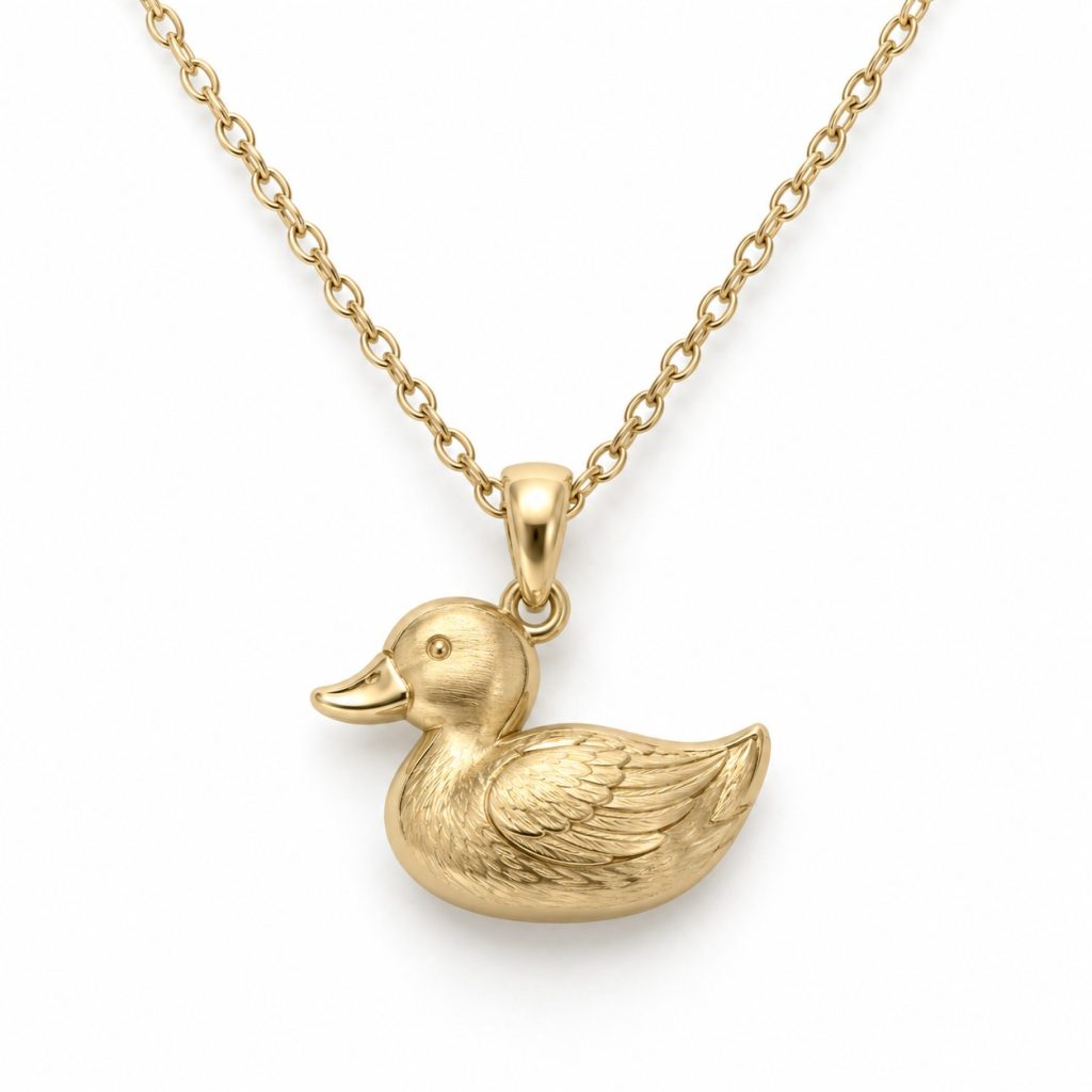 Gold-tone duck pendant necklace with sculpted feather details and an oval-link chain on a white background