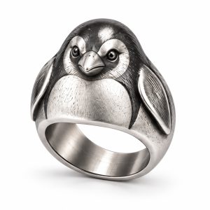 Stainless steel penguin ring with feather-inspired texture, a short metal beak and a smooth inner band.