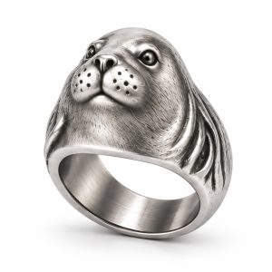 Silver-plated sea lion ring with a rounded muzzle, recessed whisker markings and a broad textured band.