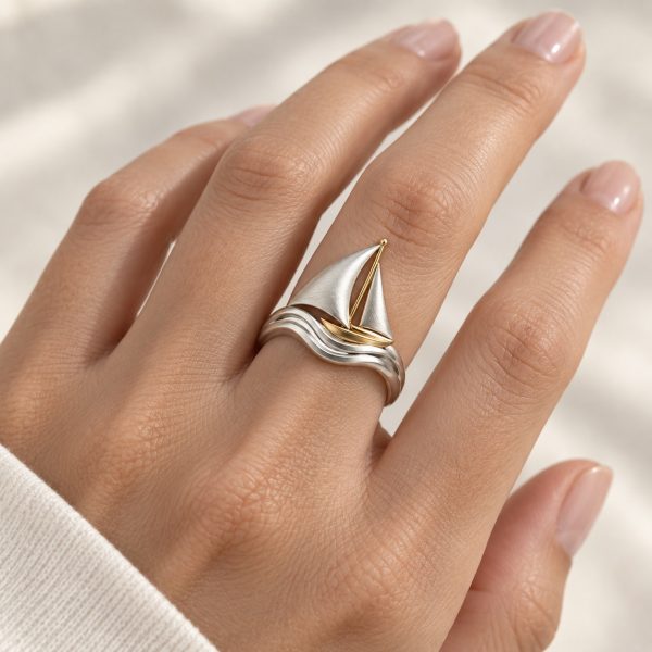 Sailboat ring with silver-tone sails and a gold-tone mast