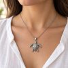 Silver-tone sea turtle pendant with a textured shell suspended from a cable chain