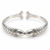 Silver-tone cuff with two fish meeting mouth to mouth, scale-textured bodies and a rear opening between their tails