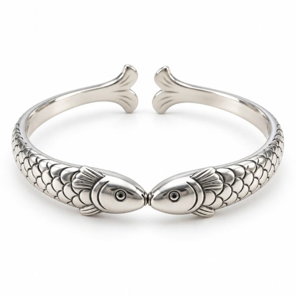 Silver-tone cuff with two fish meeting mouth to mouth, scale-textured bodies and a rear opening between their tails