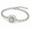 Silver-tone scallop shell chain bracelet with a raised ribbed shell centerpiece, oval links, lobster clasp and extension chain on a white background