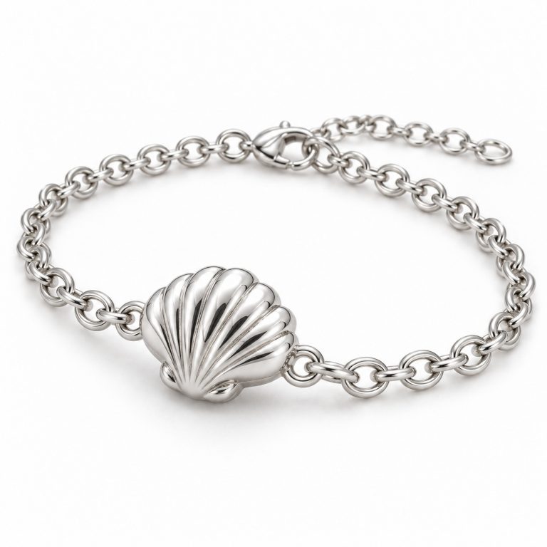 Silver-tone scallop shell chain bracelet with a raised ribbed shell centerpiece, oval links, lobster clasp and extension chain on a white background