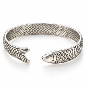 Silver-tone fish scale cuff bracelet with a sculpted fish head and forked tail facing across the front opening on a white background