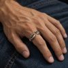 Silver-tone crab claw ring worn on a finger, showing the two pincers and open-front design