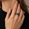 Silver-tone octopus tentacle wrap ring worn on a finger, showing its overlapping band and sucker details